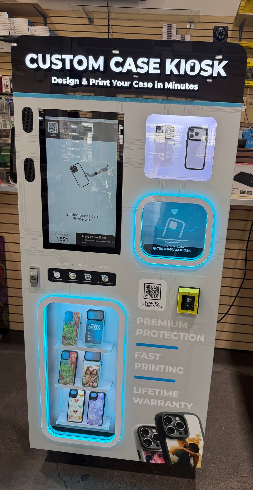 Custom Case Kiosk inside FR Wireless on Harry Hines Blvd in Dallas, Texas — the kiosk lit up with a case order in progress on screen and printed cases on the display shelves