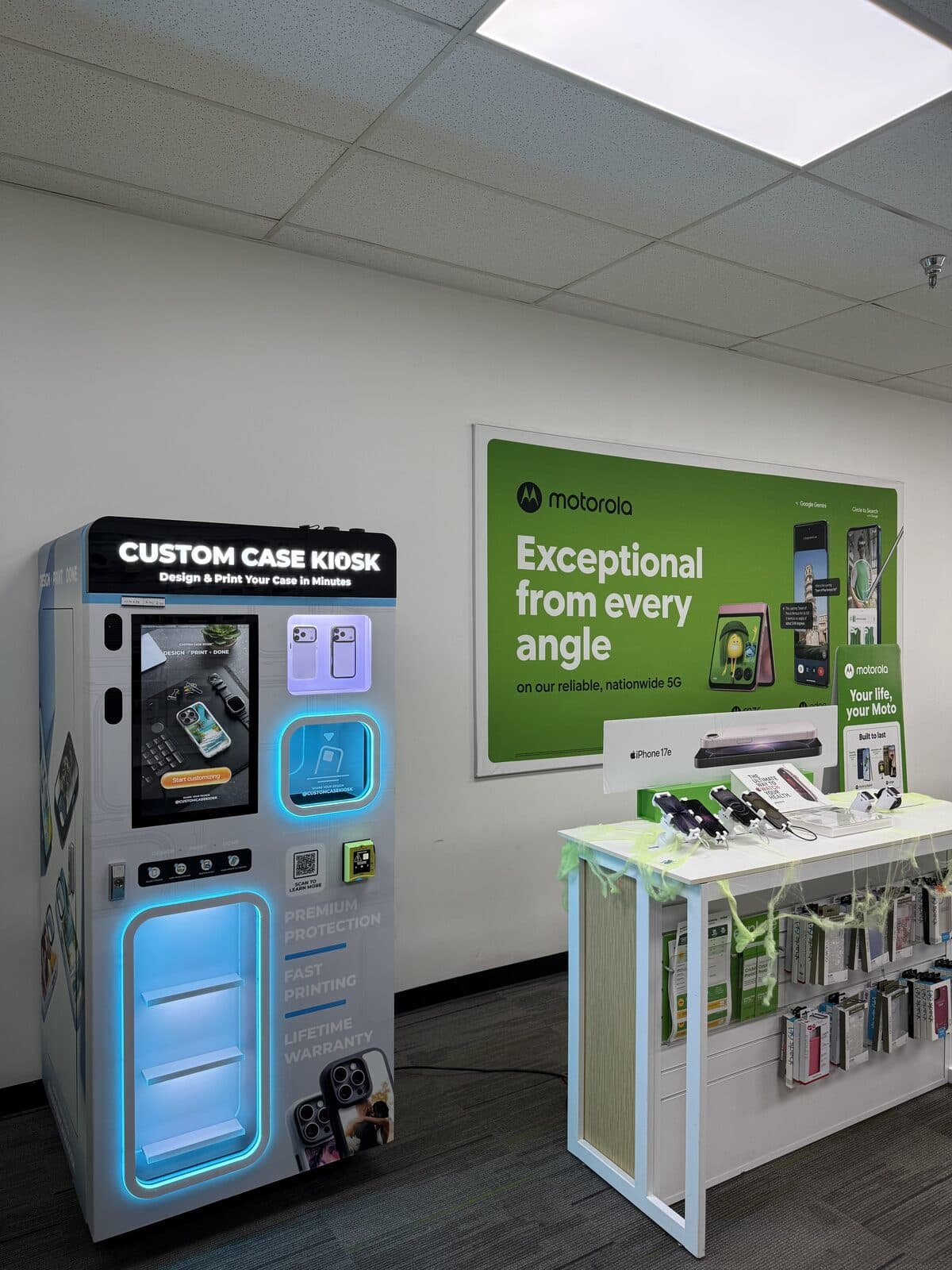 Custom Case Kiosk at Cricket Wireless in Houston's East End — the kiosk next to the phone accessory table under the Motorola wall display