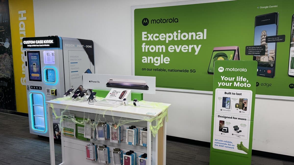 Custom Case Kiosk inside the Cricket Wireless store on Harrisburg Blvd in Houston, TX — the lit kiosk beside the accessory table and the Motorola wall display