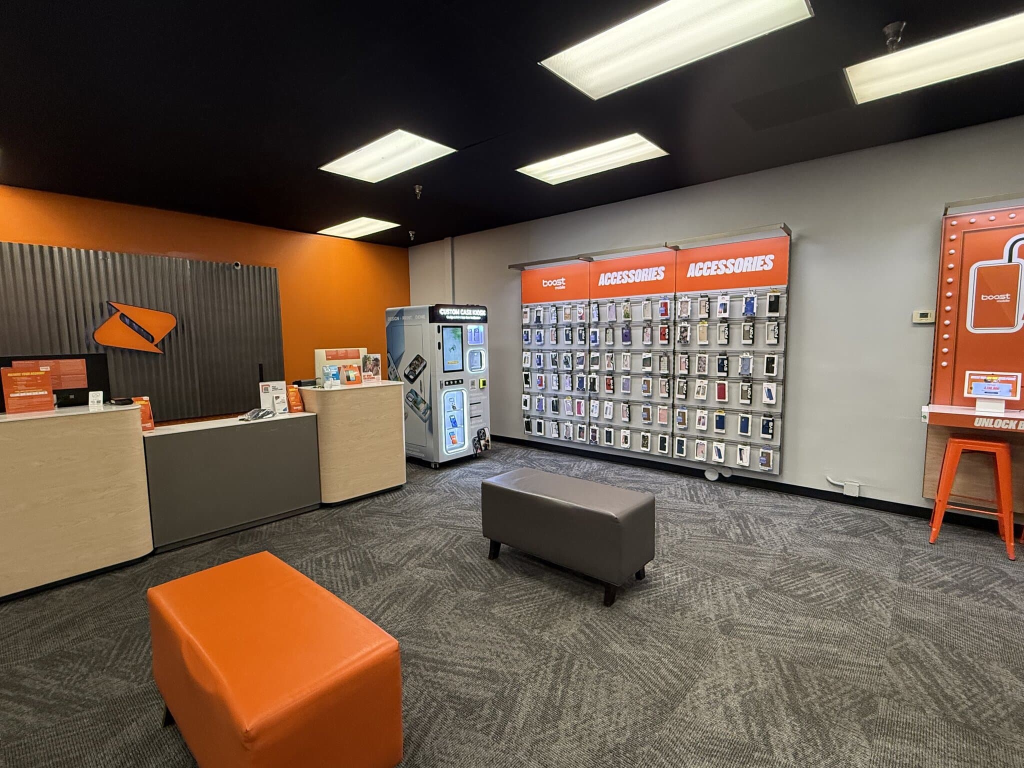 Boost Mobile store interior in the Alhambra area of Phoenix, AZ, with the Custom Case Kiosk between the front counter and the accessories wall