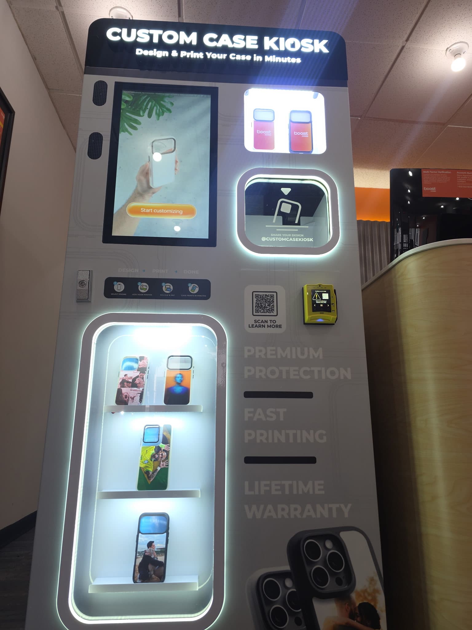 Custom Case Kiosk at Boost Mobile in Riverside, NJ — angled view of the touchscreen and case pickup window